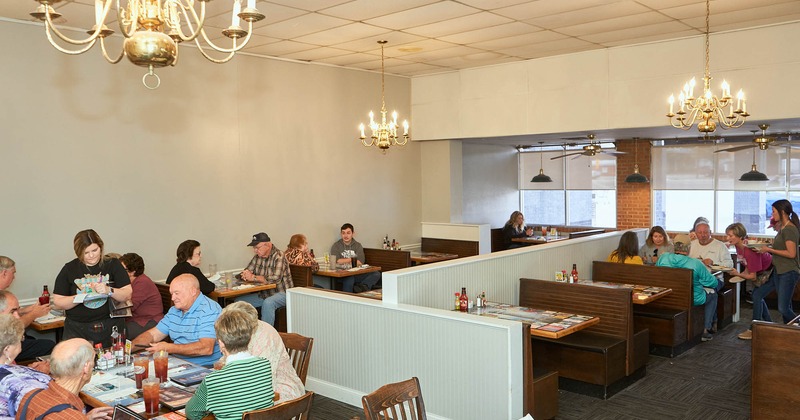 Interior, benches, tables, chandeliers, display counter, customers