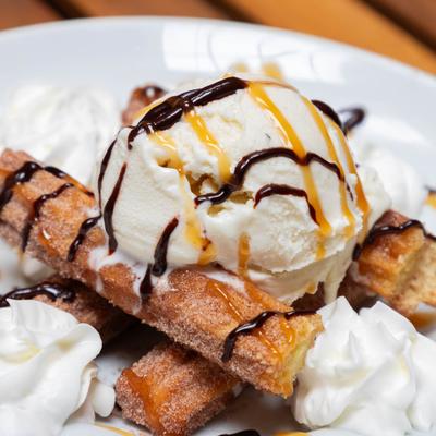 Churros, with whipped cream and ice cream.