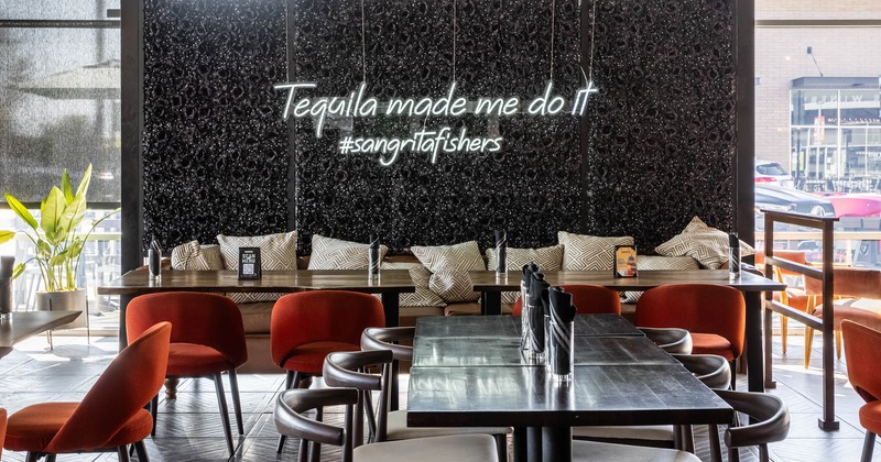 Interior, dining area, tables, chairs, and sofas with pillows