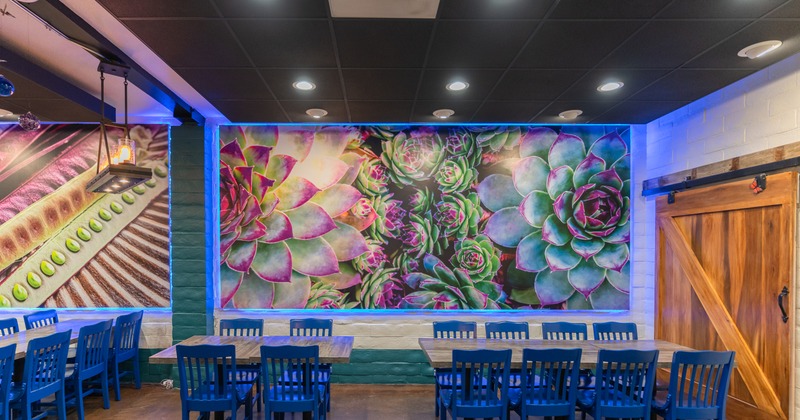 Dining area, tables, chairs and paintings on the wall