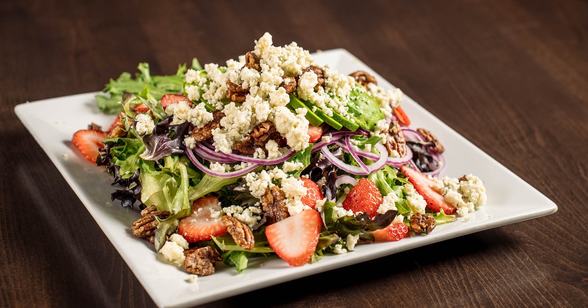 Amanda Salad with greens, strawberries, avocado slices, walnuts and crumbled cheese