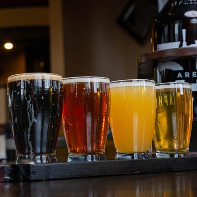 Four glasses of craft beer, each a different color.