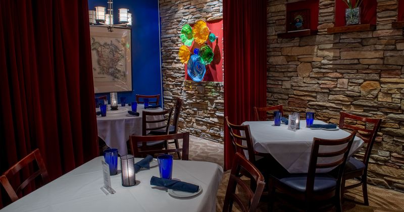 Set dining tables,red draps, framed pictures on the wall