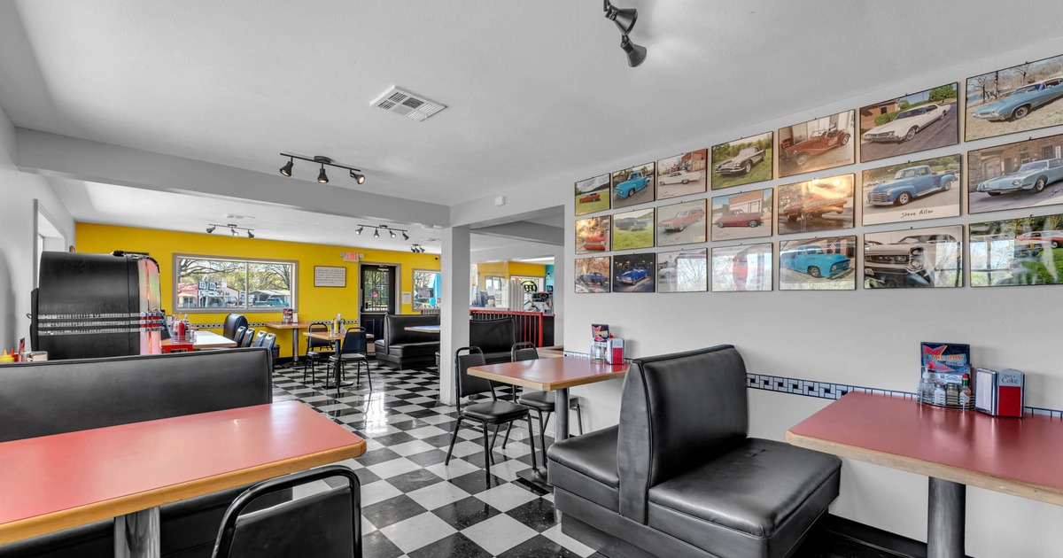 Interior seating area with chairs, tables and booths