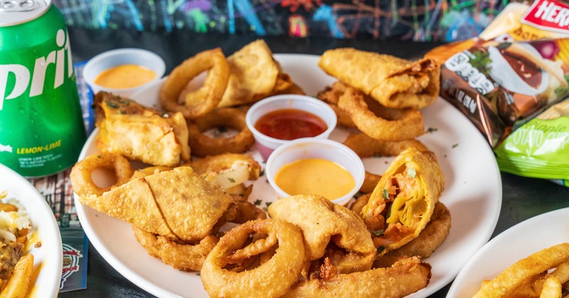 Philly Egg rolls served with sauces and onion rings