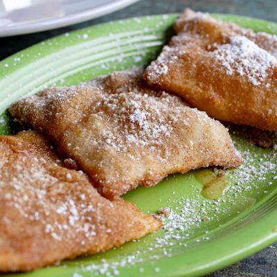 Deep-fried pastry dusted with powdered sugar