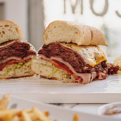 A served Morry's Sky High Triple Decker sandwich, side view.