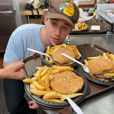Employee about to serve a tray of food.
