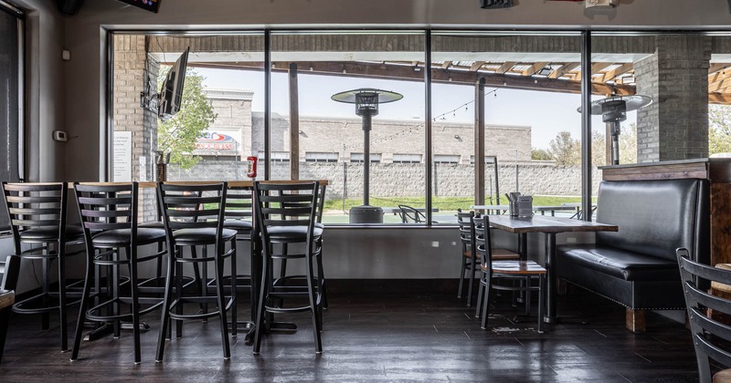 Interior, seating area, high seating table for eight, banquette bench with table and two chairs