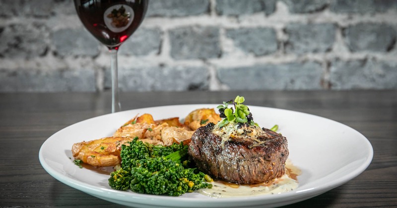 Gorgonzola Filet plate accompanied with a glass of red wine