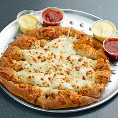 Cheese Bread served on a round, metal tray with dipping sauces.