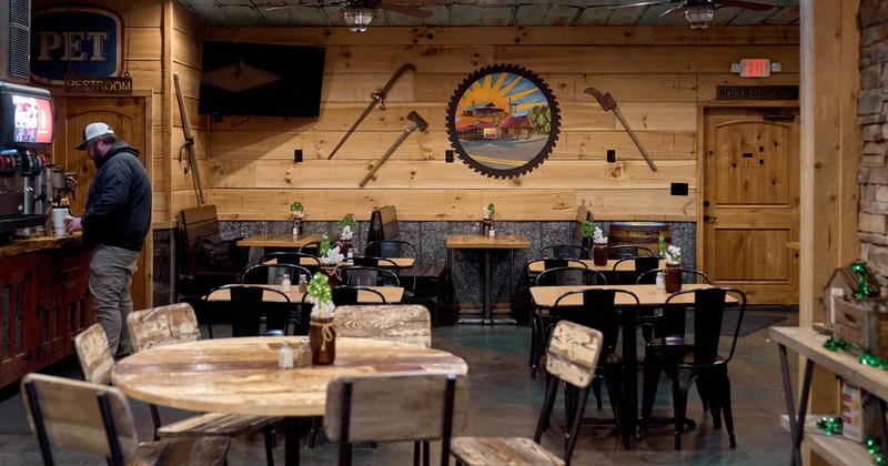 Interior, dining area, tables for six and four, seating booths in the back, soda fountain