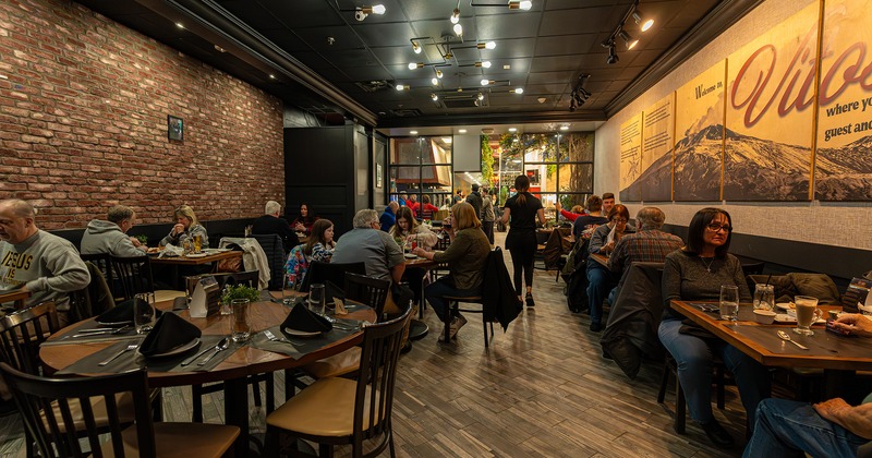 Interior space, dining area full of guests enjoying their food and drinks