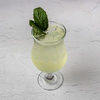 Glass of Lemonade garnished with mint spring.