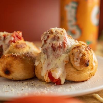 Meatball sliders topped with mozzarella and marinara.