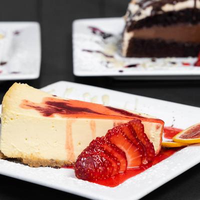 Strawberry cheesecakes accompanied with other desserts.