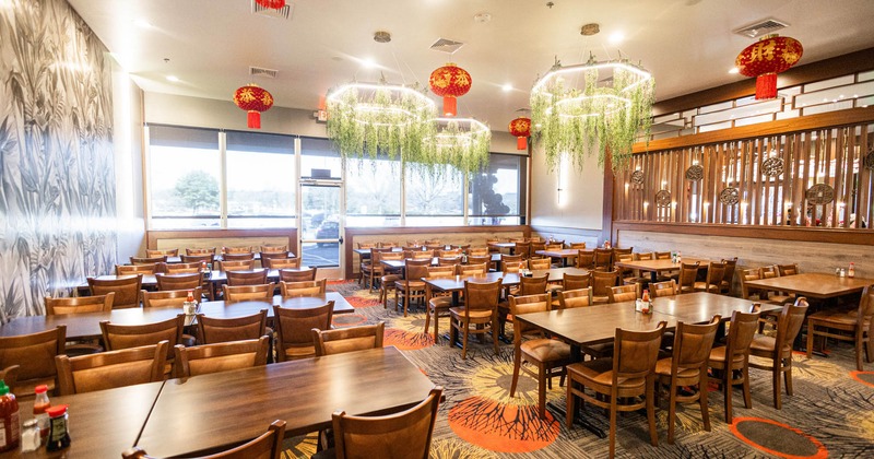 Interior, dining area, restaurant entrance, wooden top table setups for eight and four