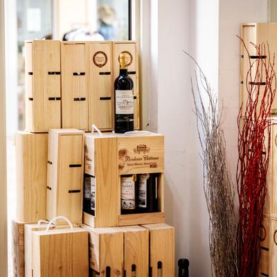 A stack of wooden wine crates with bottles.