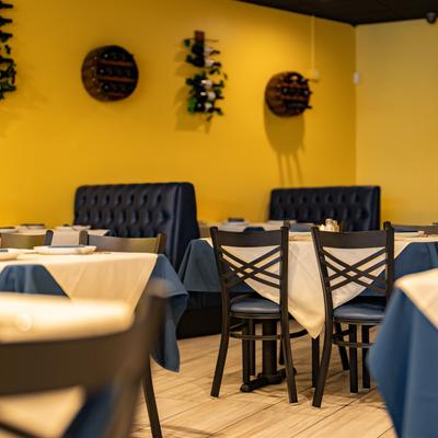 Diner area, tables and chairs, booths behind.