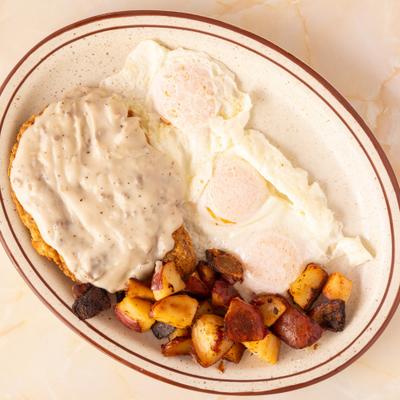 Biscuits and gravy served with eggs and home fries.