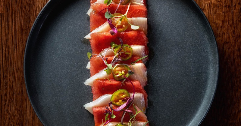 Yellowtail and watermelon sashimi topped with jalapenos and microgreens