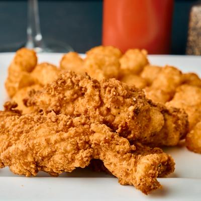 Chicken tenders served with tater tots.