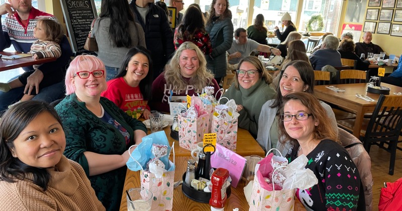 Cozy seating area with yellow painted walls covered with framed photos and music posters