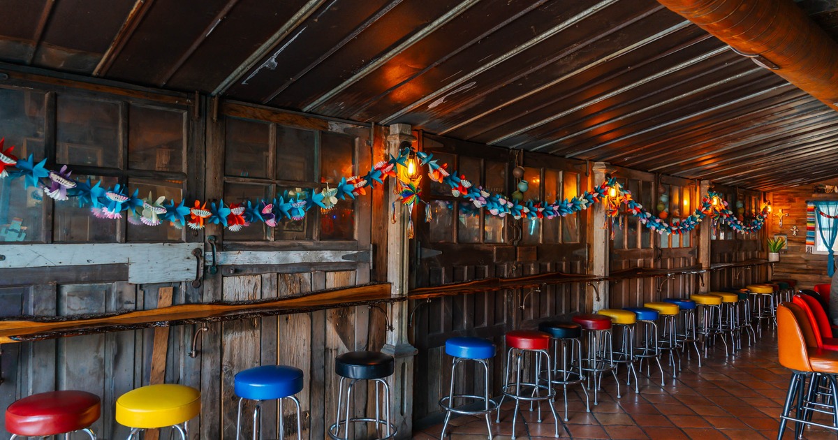 Rustic bar interior with colorful stools