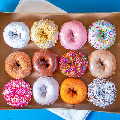 One dozen colorful donuts.