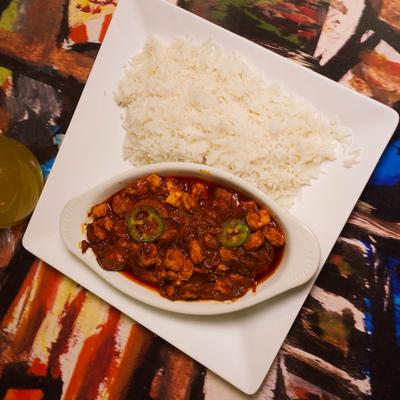Lamb stew served with rice on the side, top view.