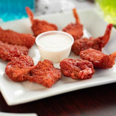 Buffalo shrimp served with a dipping sauce.