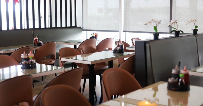 Interior, dining area, tables with chairs ready for guests, windows with blinds