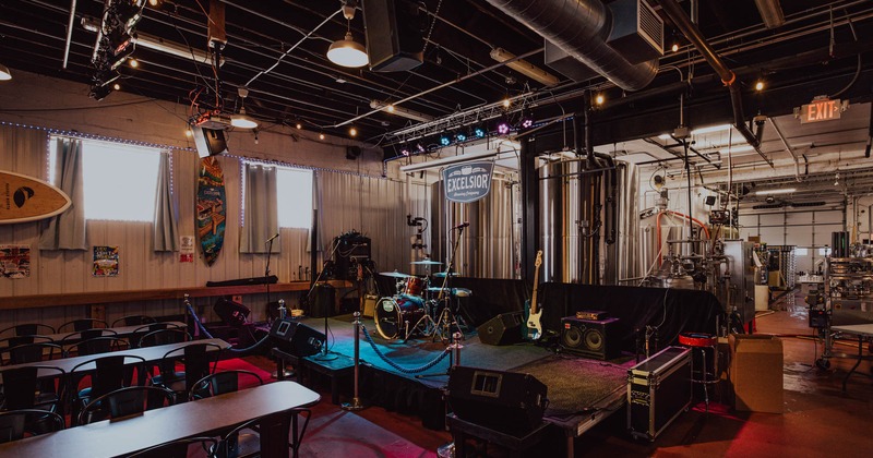 Interior seating area with chairs, tables and a stage