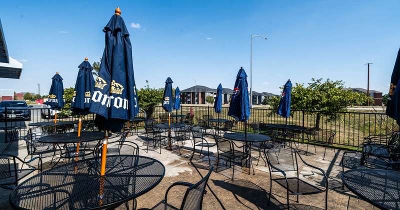Outdoor restaurant patio with tables and umbrellas