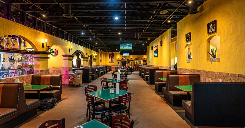 Interior dining area with booths, chairs and tables