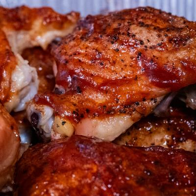 Close up of BBQ chicken pieces.