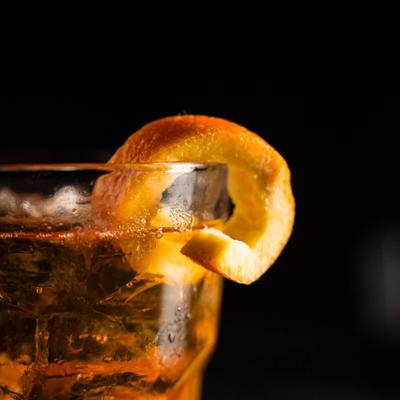 Old Fashioned cocktail with orange twist garnish.