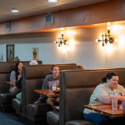 People sitting at booths.