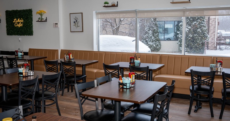 Interior, dining area, tables and chairs ready for guests, various wall decoration