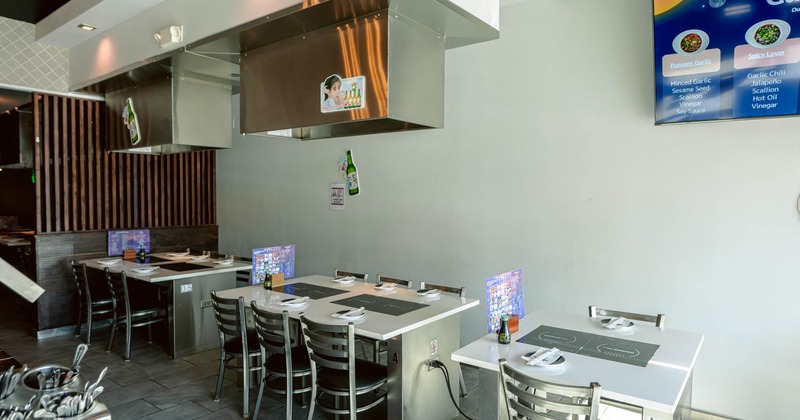 A modern restaurant interior with tables set with plates