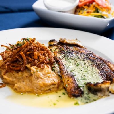 Australian Sea Bass served with savory mash topped with crispy fried onions.