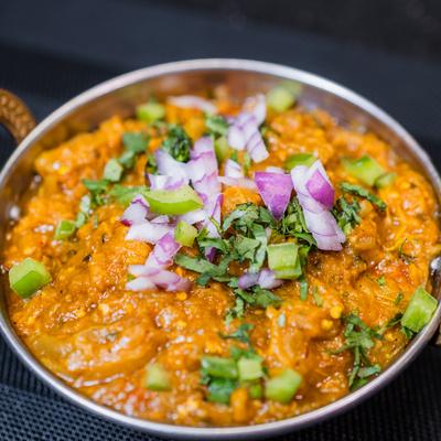 Baigan Bherta topped with with onions, cilantro and peppers.