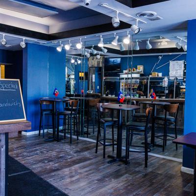 Bar area, mirror wall, bar tables, stools.