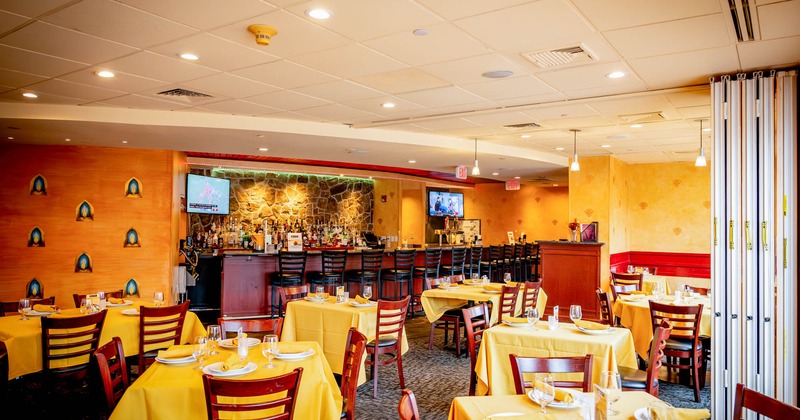 Interior, dining area, bar and bar stools in the back