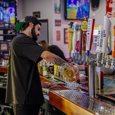 A bartender pouring drinks.