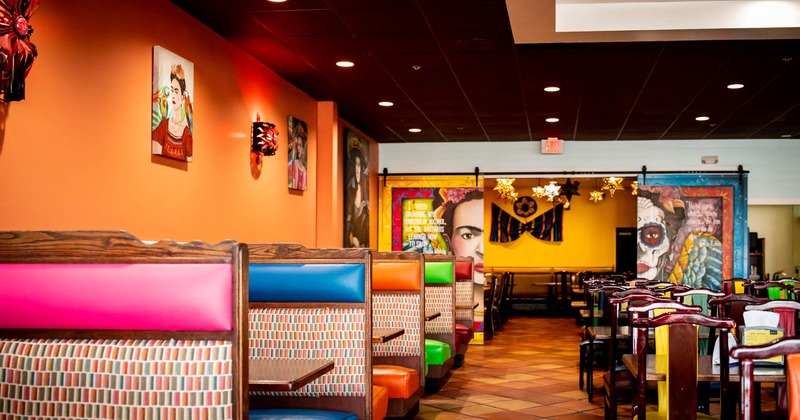 Restaurant interior, booths on the left and chairs and tables on the right