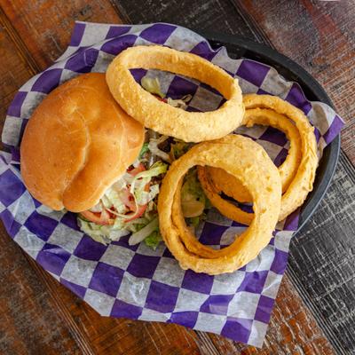 Top view of the Mushroom Swiss Burger served with onion rings.