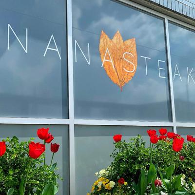 Exterior, sign on the window, red tulips.