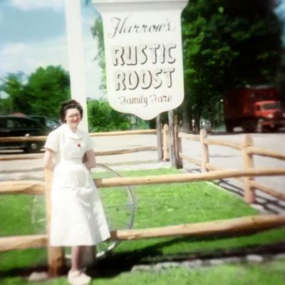 An old picture of a person standing by a sign for Harrow's Rustic Roost Family Fare.