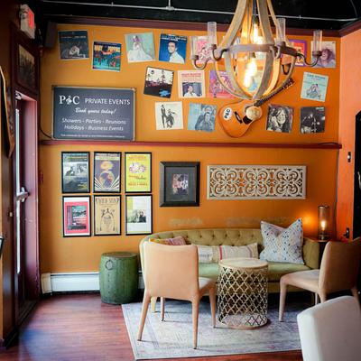 Interior, sofa, tables and chairs, posters on the wall